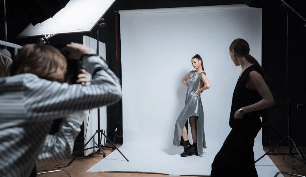 Model posing in a studio during a professional photo shoot.